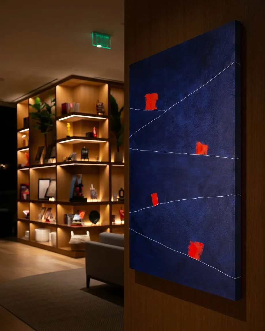 Vertical abstract painting on canvas. Textured dark blue background with four irregular red rectangular shapes. Two thin, diagonal white lines cross the composition, dividing the color fields and red forms.
