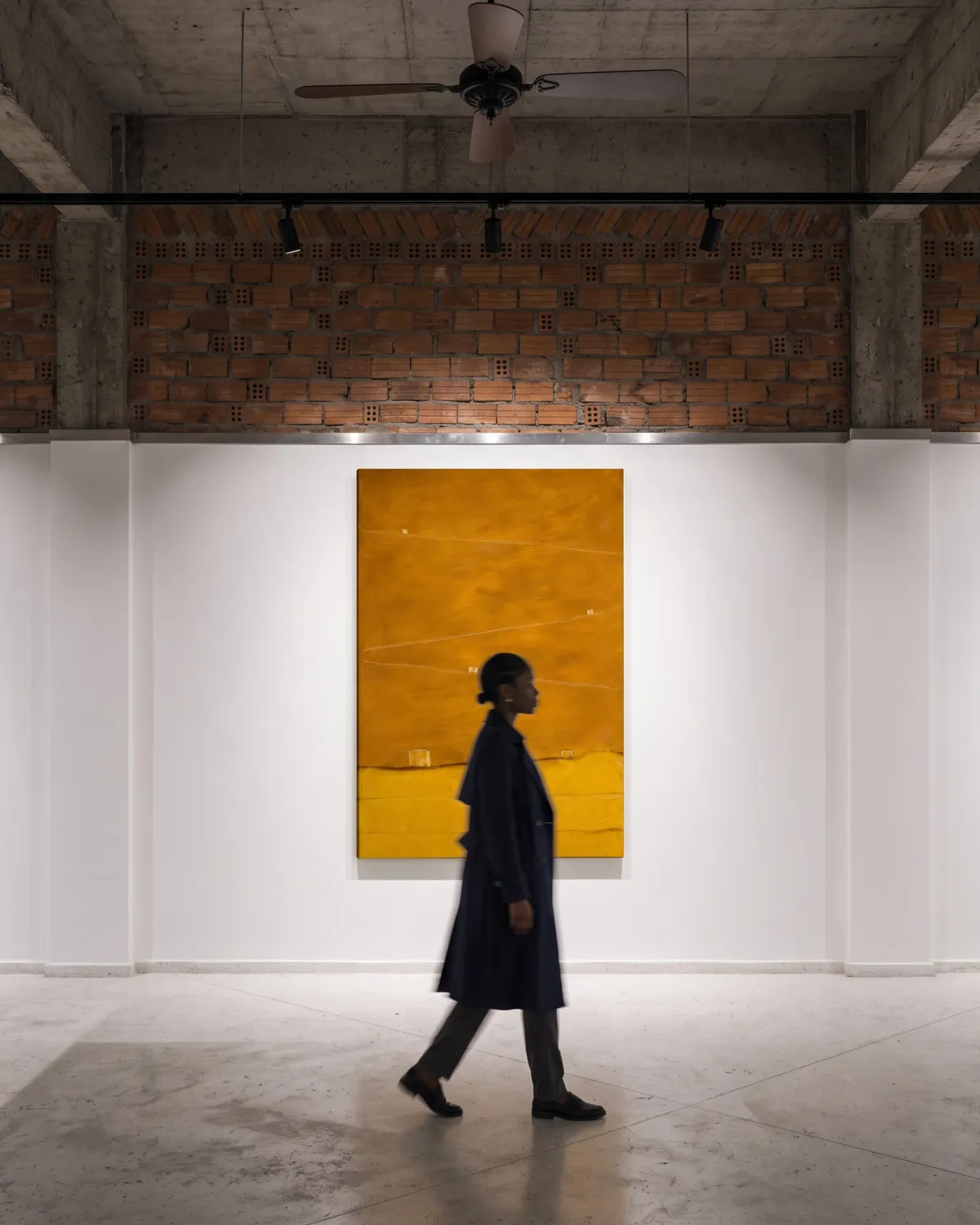 Front view of the abstract artwork QUINQUE hanging on a white wall while a person walks past in the foreground.