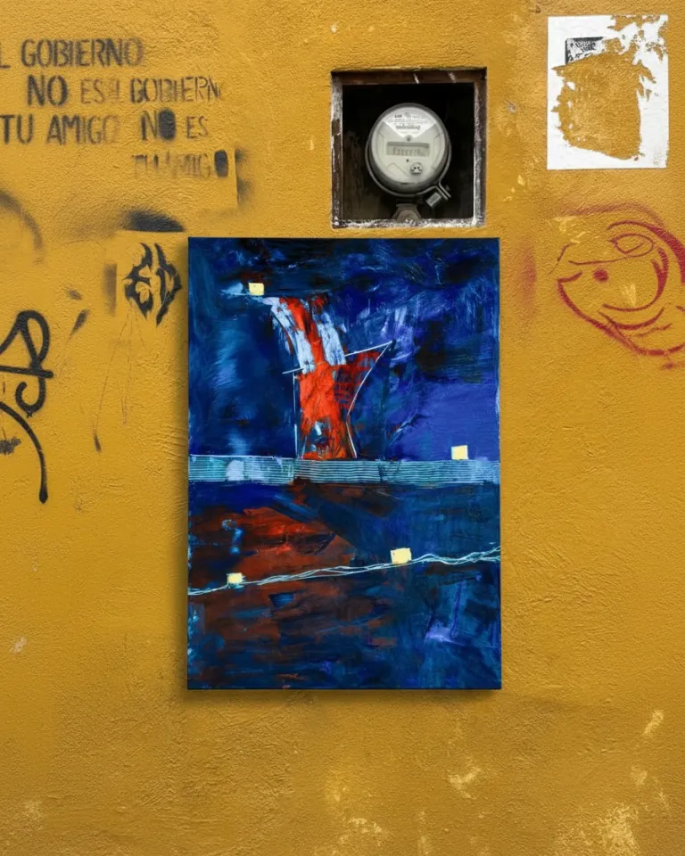 The canvas CLATHRI by Maurizio Valch hanging on an exterior yellow wall covered in graffiti, with an old electric meter above it.