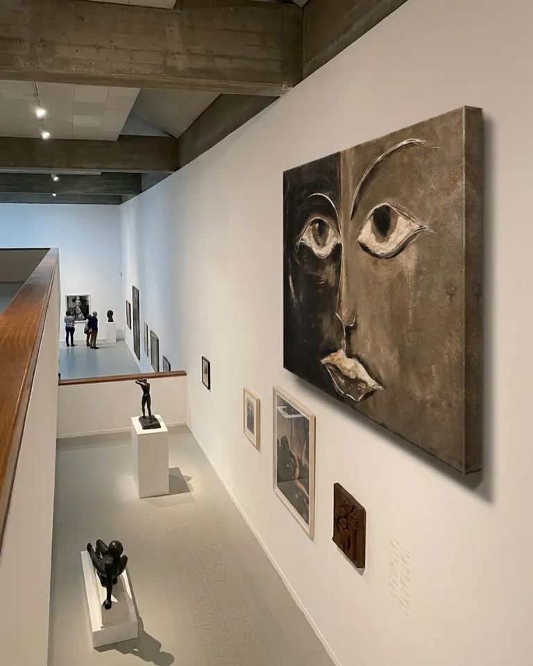 Perspective view of the artwork by Maurizio Valch hanging on a modern gallery wall, overlooking a lower level with sculptures.