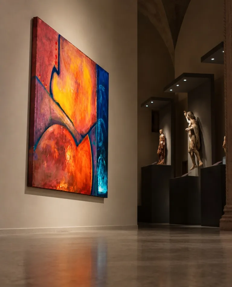The painting VERSUM by Maurizio Valch hanging on a gallery wall illuminated by spotlights, alongside classical sculptures on pedestals in a deep hallway.