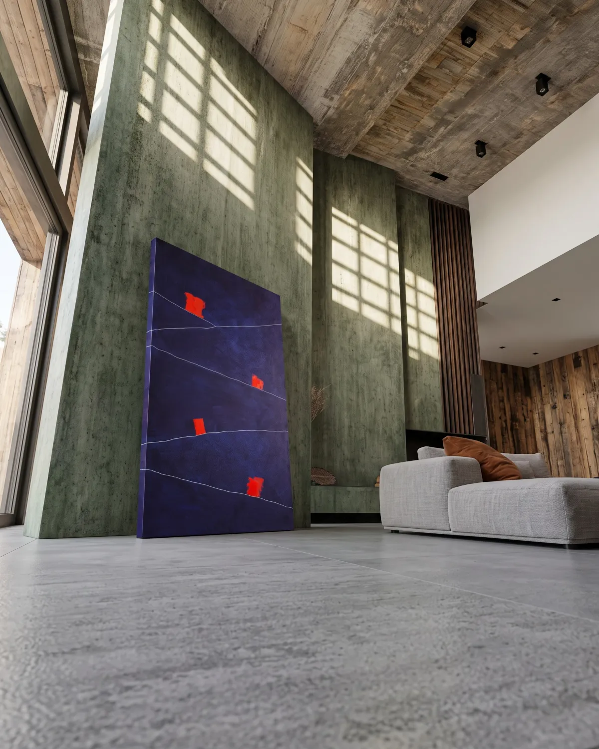 Large abstract painting by Maurizio Valch leaning on the grey floor in a spacious exposed concrete living room with green walls.