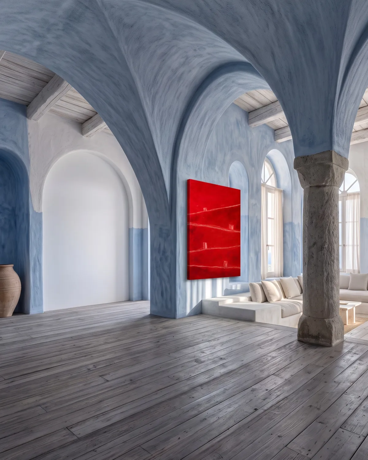Red abstract painting by Maurizio Valch hanging on the wall of a large Mediterranean-style living room with blue arches and stone columns.