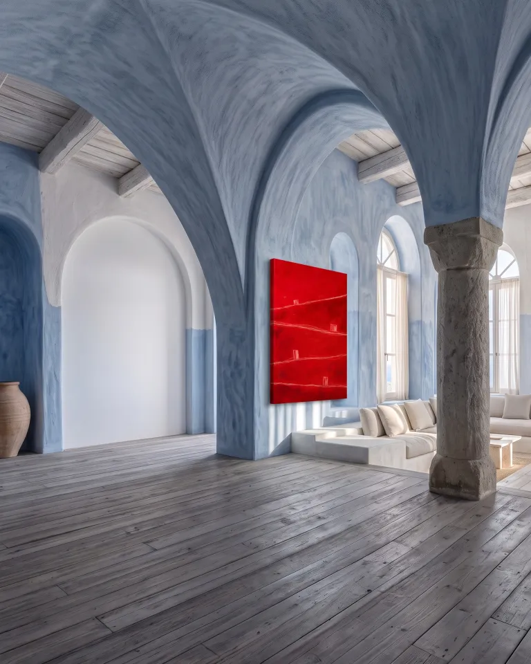 Red abstract painting by Maurizio Valch hanging on the wall of a large Mediterranean-style living room with blue arches and stone columns.